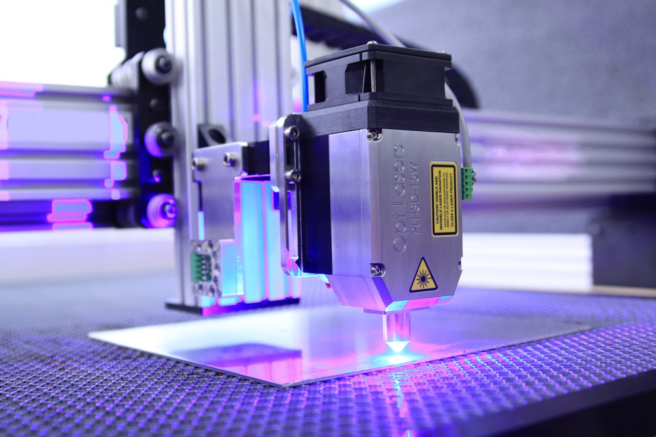 hero-img-01 Detailed view of an industrial laser engraving machine in action, highlighting precision equipment.